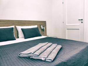 a bed with two folded towels on top of it at Guest House S.Caterina in Viterbo