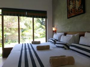 a bedroom with a large bed with a large window at Green Wood Villa Negombo in Negombo +183 photos