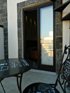 a table and chairs on a patio with a window at Il Borghese Tourist House in Gela +40 photos