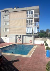 a building with a swimming pool in front of a building at Alpen1 Forner in Peñíscola