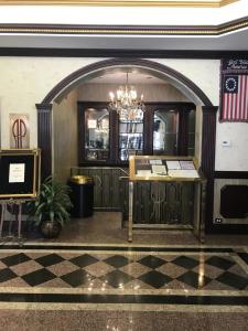 an entrance to a restaurant with a chandelier at The Avenue Plaza in Brooklyn