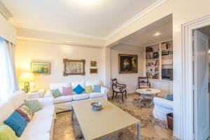 a living room with a white couch and a table at Casa en la Corredera in Vejer de la Frontera