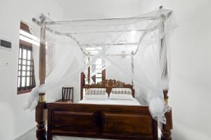 Postel nebo postele na pokoji v ubytování Knight Inn - Galle Fort