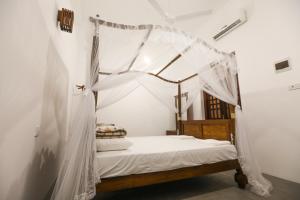 Postel nebo postele na pokoji v ubytování Knight Inn - Galle Fort