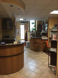 a restaurant with a counter and a bar in a room at Hotel Dora in Turin