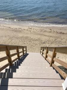 a wooden boardwalk leading to the beach at The Garlands Motel in Dennis Port