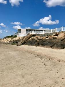 a building on top of a rocky beach at The Garlands Motel in Dennis Port