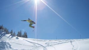 un hombre volando por el aire mientras monta una tabla de snowboard en Hotel Alpenhof, en Oberau