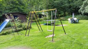 einen Spielplatz mit Schaukel im Hof in der Unterkunft Ferienhaus Erika in Zorge