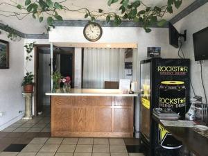 a kitchen with a counter and a clock on the wall at Americas Inn Bardstown in Bardstown