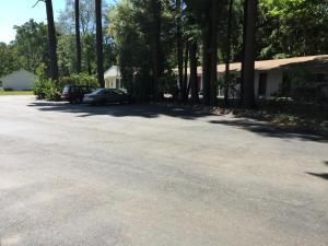 a driveway with a car parked in front of a house at North King Motel in Northampton