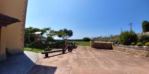 a couple of benches sitting on a patio at Apartamentos Antonio in Ubiarco