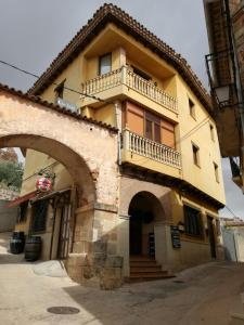 un edificio amarillo con balcón en la parte superior en Casas Rurales Canserta, en Alcaraz