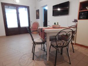 a dining room with a table and two chairs at B & B LE TRE B in Fano