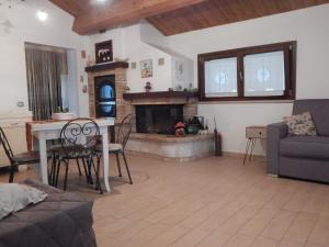 a living room with a table and a fireplace at B & B LE TRE B in Fano