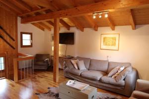 a living room with a couch and a table at Mountain Village Chalet in Saas-Fee