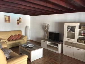 a living room with a couch and a tv at Villa Lucky - Heated Pool in Mácher