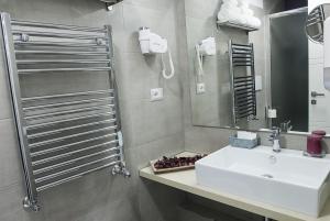 a bathroom with a sink and a mirror at Merulana Holidays in Rome