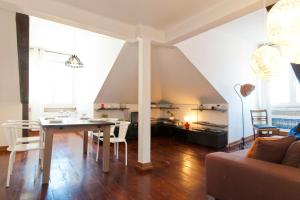 a living room with a table and a couch at Casa da Baixa, Renovated Beautiful 2 Bedroom Downtown Apartment in Lisbon