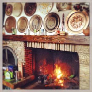 a fireplace with plates and dishes on a wall at B&B ANNA in Forlì