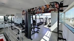 a gym with treadmills and cardio equipment in a building at Porto Minas Hotel e Convenções in Uberlândia