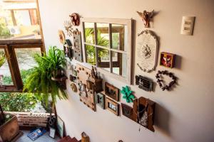 a wall with a bunch of pictures on it at Pousada Santarina in Florianópolis