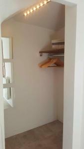 a room with white walls and shelves with books at Forcal in Forcalquier