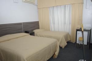 Voodi või voodid majutusasutuse Rioma Hotel toas