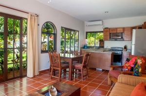 Casa Anita في بويرتو موريلوس: مطبخ وغرفة معيشة مع طاولة وكراسي