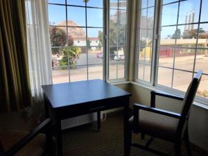 a table and two chairs in front of a window at Fireside Inn in Morro Bay