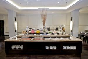 a large room with a table with food on it at Samala Hotel Jakarta Cengkareng in Jakarta