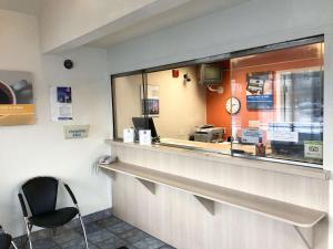 a fast food restaurant with a counter and a chair at Motel 6-Enfield, CT - Hartford in Enfield