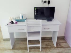 a white desk with a computer on top of it at The Big House in Colombo