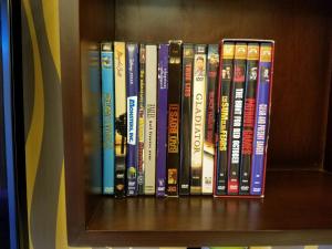 a row of books sitting on a book shelf at Pico de Loro Lagoon View in Nasugbu