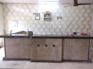 a counter top in a room with a wall at Hotel Surya in Mangalore