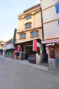 a building on the side of a street at Mannars Deluxe Lodge in Mysore