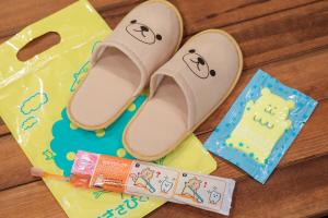 a pair of sandals sitting on a table with a cake at Hotel Double Funabashi in Funabashi