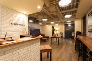 an office with a counter and a bar with tables at Hotel Double Funabashi in Funabashi