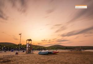 a couple of boats on the beach at sunset at Hotel Portonuovo in Vieste