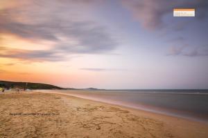 a view of a beach at sunset at Hotel Portonuovo in Vieste