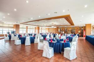 a large banquet hall with blue tables and white chairs at Ilsung Condo Namhan River in Yeoju