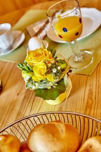 a table with a plate of food and a glass of juice at Ferienwohnung Wittmann in Garmisch-Partenkirchen