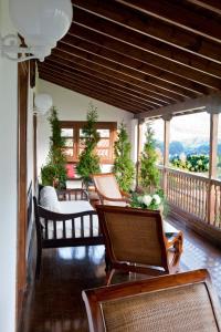 a porch with chairs and a balcony with a view at Hotel Casona Cuervo in San Tirso de Candamo