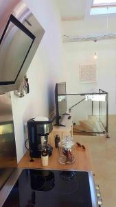 a counter with a coffee maker on a desk at Forcal in Forcalquier