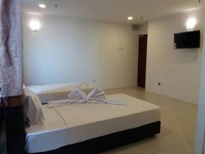 Postel nebo postele na pokoji v ubytování T-Hotel Ipoh