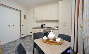 a kitchen with a table with two white vases on it at B&B Cornelia in Pompei