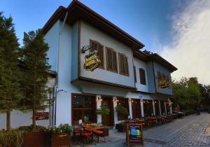 a building with tables and chairs outside of it at Route Hotel Kaleici - Adult Only (12+) in Antalya