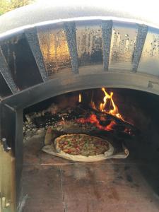 a pizza is being cooked in an oven at Villa d'escane in Escanecrabe