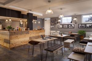 um restaurante com mesas e cadeiras e um bar em Peckham Rooms Hotel em Londres