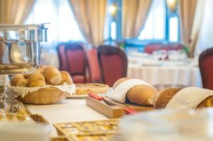 a table with bread and baskets of bread on it at Hotel Eliseo Park's in Sant'Agnello